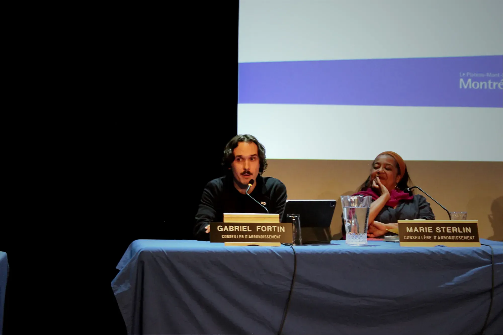 M. Fortin prend la parole lors de la séance ordinaire du conseil d'arrondissement, avec Marie Sterlin, qui l'écoute à sa gauche. 